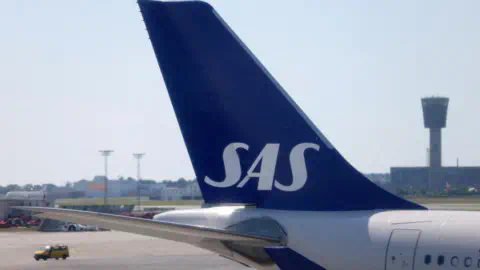 Reuters The tail fin of a parked Scandinavian Airlines (SAS) airplane is seen on the tarmac at Copenhagen Airport in July 2022